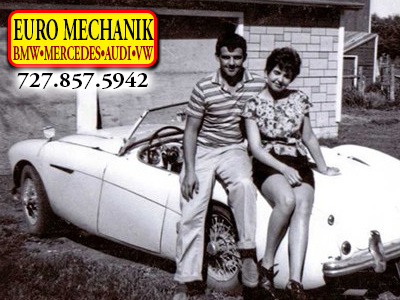Photo of a couple hugging on an old european car with Euro Mechanik Logo